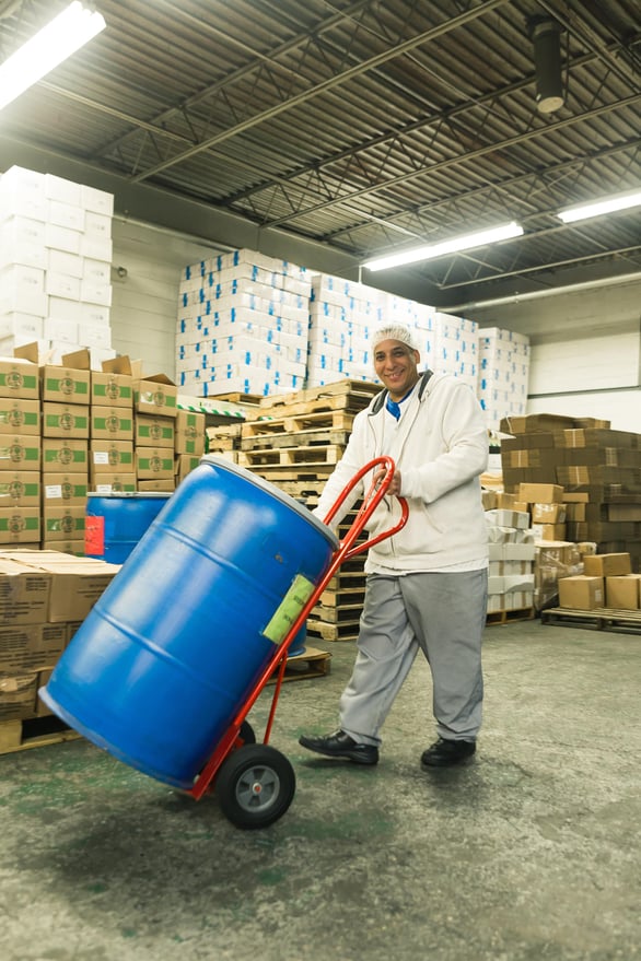 Happy injured worker pushing barrel after completing retraining program Separovic Injury Lawyers